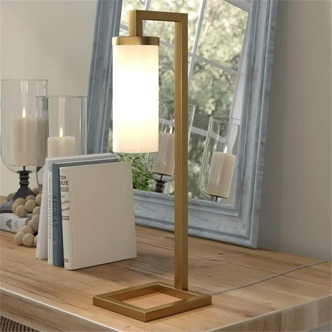 Tall Floor Lamp With Glass Milk Shade In Brass Finish, Stands At 67.75 Inches Tall, Steel Base, on wooden desk with books and candles