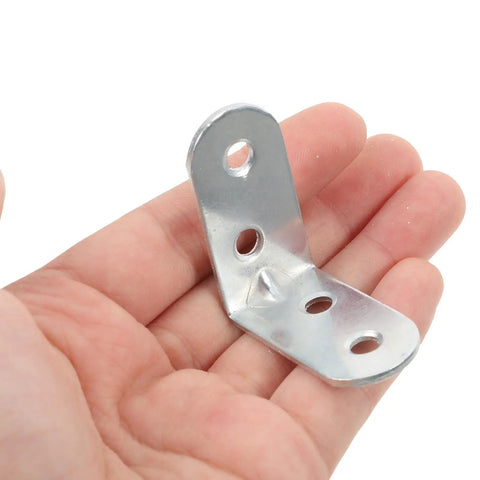 Stainless Steel L Bracket Corner Desk Connector With Easy Install And Compact Design held in hand for size comparison