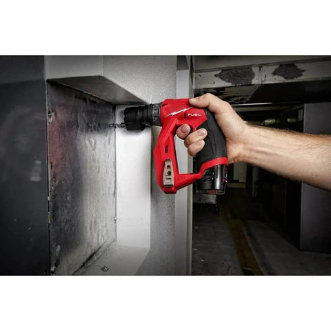 Professional Installation Drill And Driver Featuring All Steel Three Eighth Inch Chuck And Multiple Hex Adapters And Lightweight Cordless Power Tool With Heavy Duty Belt Clip And Spacious Contractor Bag For Tough Trade Work in use, drilling into a wall.