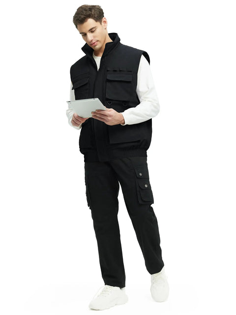 Mens Fleece Lined Winter Vest Windproof Water Resistant Outerwear with secure pockets in black worn by man holding a tablet.