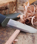 Companion Carbon Steel Fixed Blade Knife With Sheath 4.1 Inch Blade Military Green shown carving wood shavings