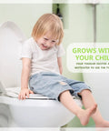 Child sitting on elongated toilet seat with built-in toddler seat slow close fits adult and child potty training ready magnetic kids seat