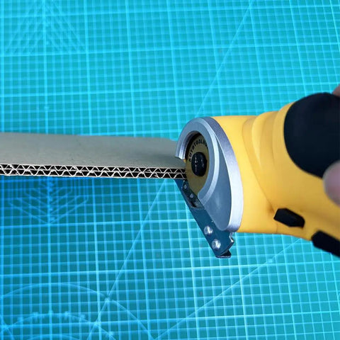 Heavy Duty Replacement Blades For Worx ZipSnip Electric Scissors cutting through cardboard with a rotary cutter.