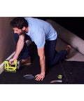 Man using Heavy Duty Cordless Electric Stapler Beast For Upholstery Carpet Home Decorative Projects on a carpet.