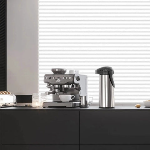 68 Oz Thermal Coffee Carafe With Pump Stainless Steel Insulated Dispenser on kitchen counter next to coffee maker
