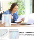 Colorful Bubble Mailer Bags 15 By 20 Cm Plus 4 Cm Waterproof Padded Envelopes held by a person with a woman smiling in the background.