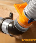 Heavy Duty Flexible Clear Dust Collection Hose Kit Featuring 4 Inch By 20 Feet Tubing Cone Reducer Elbows Fittings And Blast Gates connected to workshop table, showing elbow fitting and clamps.