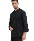 Straight Fire Kickass Chef Coat Black Long Sleeve Kitchen Workwear worn by a man, featuring a solid black design and practical pockets.