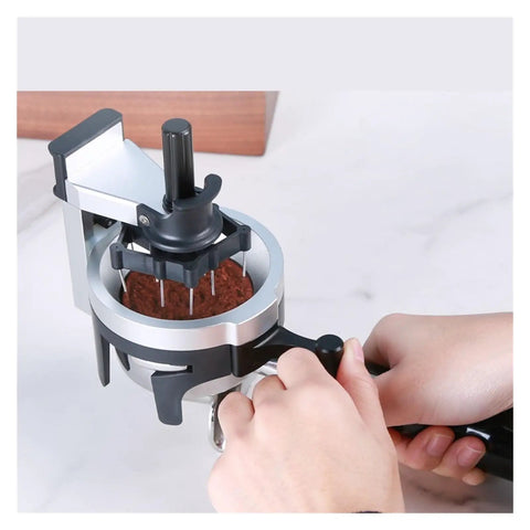 Badass Espresso Stirrer And Coffee Distribution Tool For Leveling Portafilter Pucks, hands using the steel tool on coffee grounds.