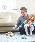 Father and daughter playing with Small Off Road Pickup Truck Model Toy Figure For Kids And Collectors on living room carpet
