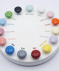 Upgrade Your Cabinets With This Sweet Set Of Sixteen Coral Pink Ceramic Cabinet Knobs Featuring Smooth Round Profiles No Sweat Installation And Top Shelf Hardware color sample display with various ceramic knobs.
