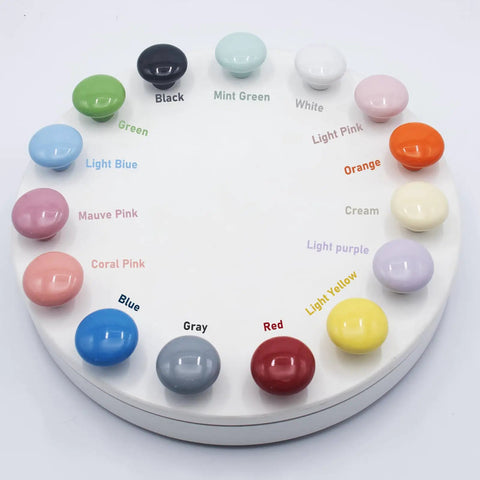 Upgrade Your Cabinets With This Sweet Set Of Sixteen Coral Pink Ceramic Cabinet Knobs Featuring Smooth Round Profiles No Sweat Installation And Top Shelf Hardware color sample display with various ceramic knobs.