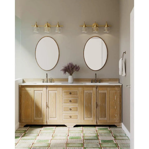 Archie Collection Clear Double Prismatic Glass Coastal Bath Vanity Light Fixture Three Light Vintage Brass Finish in bathroom