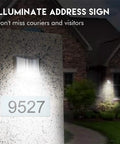Top Notch Solar Step Lights For Outdoor Fence Deck And Stair Paths Cold White LED post lamp illuminating an address sign on stone wall.