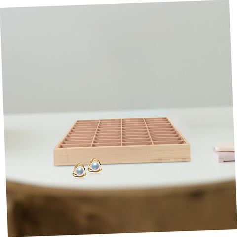 Slick Multi Grid Jewelry Tray Wooden Desktop Organizer Phone Stand For Rings Earrings And Bracelets on white table with earrings.