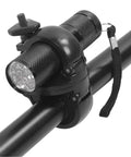 Mounted flashlight holder on bicycle handlebar with secure clamp mechanism.