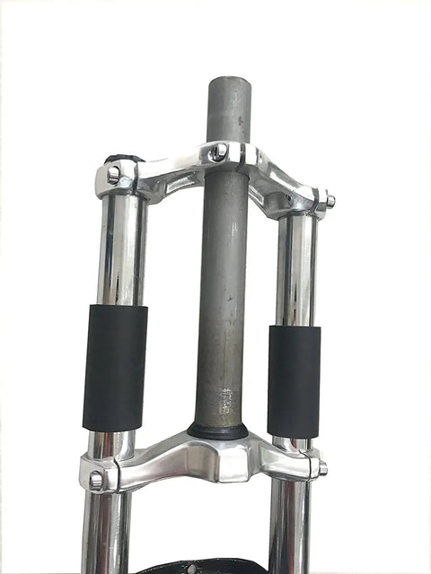 Black 26 Inch Triple Tree Front Suspension Fork With Double Shoulder Mounts For 26 Inch Mountain Bikes One Eighth Inch Headset Disc Brake Compatible Fits 44mm Head Tube And 28.6 Fork Ride Ready 26x2.325 Tire Width close-up on construction detail.