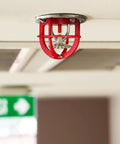 Tough As Nails Fire Sprinkler Head Guard Cover Bump Proof Protector Cage mounted on ceiling, 3.34 inch installation, red durable design.