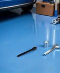 Crankshaft Pulley Removal Tool Gear Puller Kit with wrench and components on garage floor near car