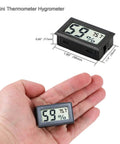 12 Pack Mini Digital Hygrometer Thermometer Indoor Humidity Gauge With Fast 10 Second Readings in hand showing dimensions