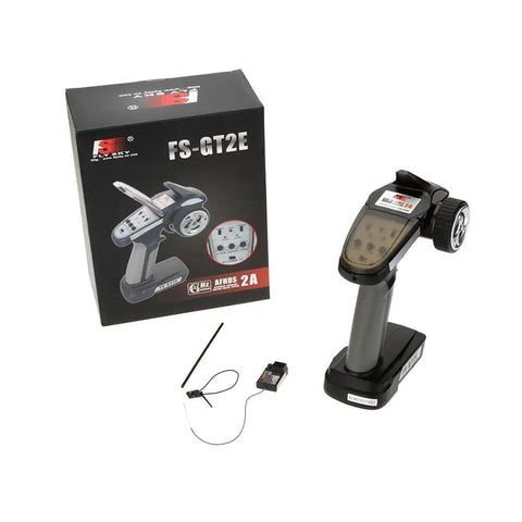 FS GT2E AFHDS 2A 2.4GHz 2CH RC Transmitter For Car And Boat with box, handheld controller, and FS A3 receiver visible.