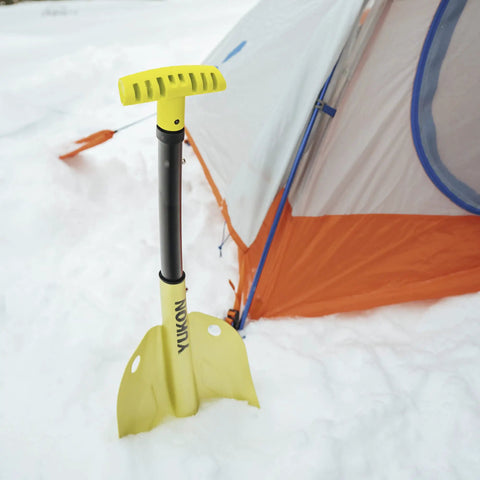 Grab And Go Collapsible Snow Shovel For Camping And Car Emergency Kit next to orange tent in snow, black handle, yellow blade