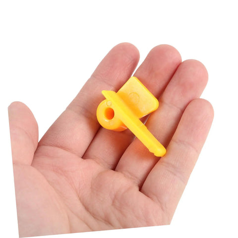 Pro Grade Tire Changer Head Protector Guards 2 Pack Yellow Scratch Resistant Jaw Covers shown on hand for scale