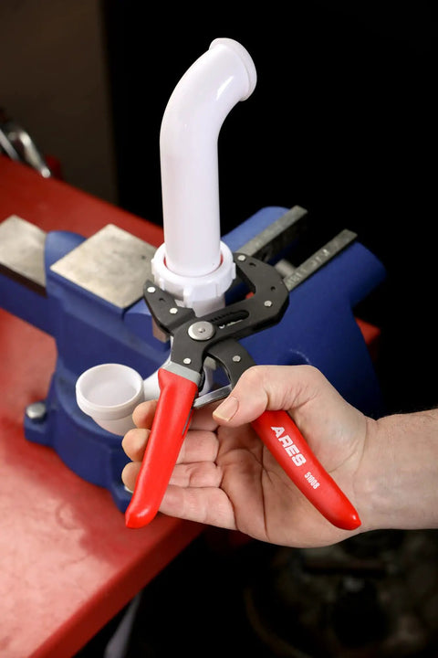 2-Piece Self-Adjusting V-Notch Pliers Set 7-Inch And 10-Inch used on PVC pipe held in blue vise