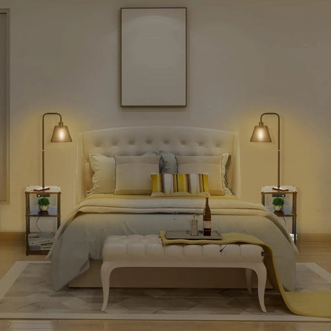 Bedroom setup with two No Fuss All In One Floor Lamps with tables and shelves, built-in USB ports and outlets, beside a bed.