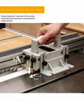 Heavy Duty Adjustable Three Way Force Push Block For Table Saws Jointers on a saw table applying three-directional pressure.