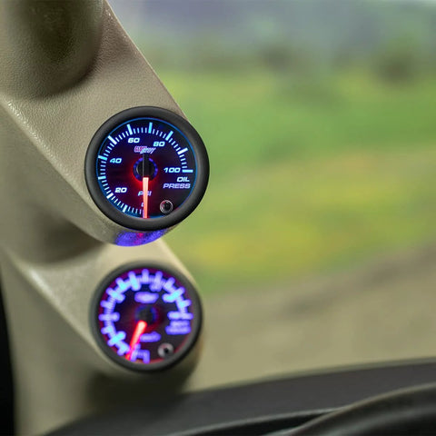 GlowShift oil pressure gauge, 2-1/16 in (52mm), black dial with blue backlit display, mounted in car