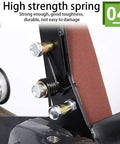 Close-up of high strength spring on belt sander attachment kit for angle grinder, showing bolts and sanding belt.