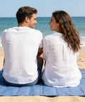 Couple sitting on Pocket Picnic Blanket For Grab And Go Outdoor Fun That Folds Small And Lightweight Sandproof 55 By 60 Inch Beach Mat