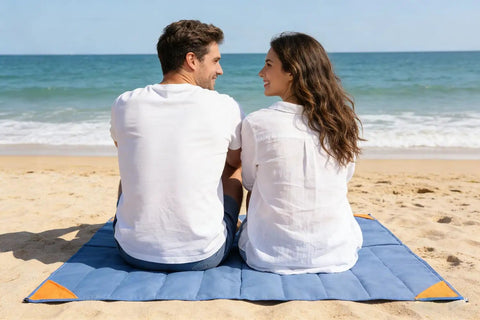 Couple sitting on Pocket Picnic Blanket For Grab And Go Outdoor Fun That Folds Small And Lightweight Sandproof 55 By 60 Inch Beach Mat