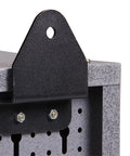 Close-up of a black and grey metal wall cabinet with lockable door, pegboard interior, and sturdy construction for tool storage.