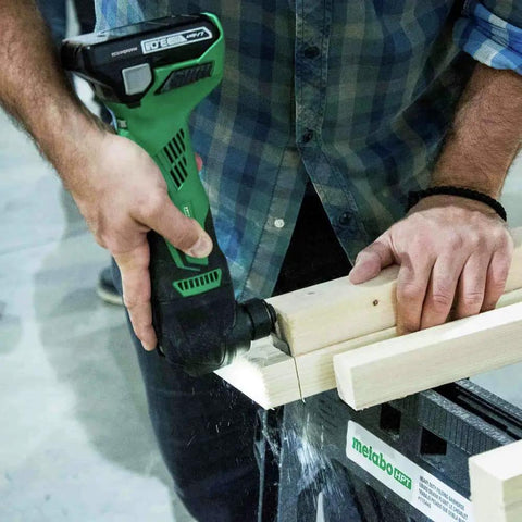 Person using 18V Cordless Oscillating Multi Tool With Brushless Motor, Variable Speed 6000 To 20000 RPM, on wooden planks