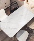 Glossy Marble Peel And Stick Wallpaper Gray And White Slick Look applied on dining table surface, 15.8 inch by 393 inch roll