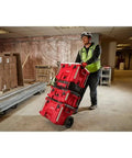 Worker moving PACKOUT 40QT XL Cooler Box with Impact Resistant Polymer Body Drain Plug and modular connectivity on job site