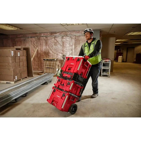 Worker moving PACKOUT 40QT XL Cooler Box with Impact Resistant Polymer Body Drain Plug and modular connectivity on job site