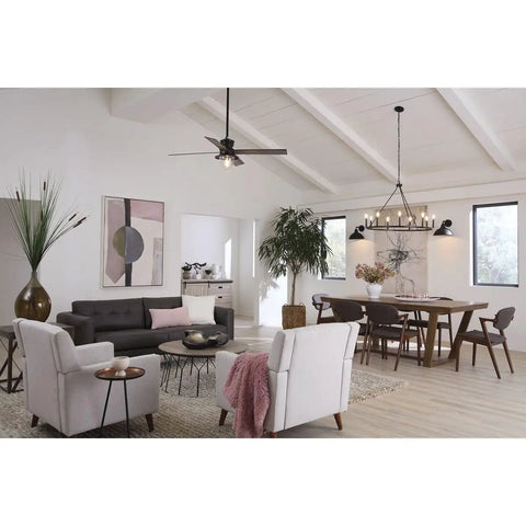 Modern living room with a black ceiling fan, white walls, and a dining area featuring a rustic wood table and chairs under a chandelier.