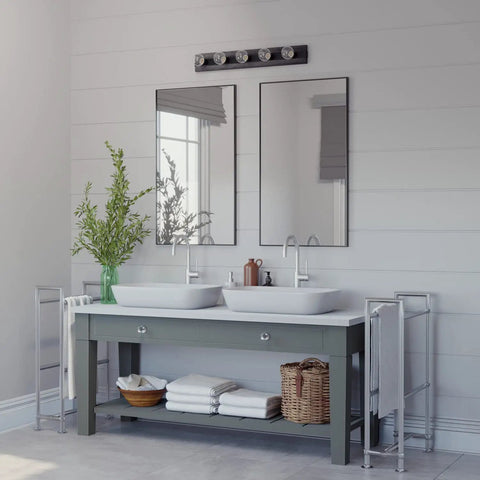 Donelson Vanity Light In Natural Iron Finish above double sink bathroom with mirrors, transitional modern bath lighting setup.