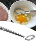 Two Piece Stainless Steel Mini Egg Whisk Set With Spring Coil Design For Effortless Mixing, Frothing And Beating In Coffee, Milk, Sauces And Desserts, Rust Resistant And Durable Handheld Kitchen Tool shown beside ingredients in a bowl.