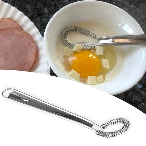 Two Piece Stainless Steel Mini Egg Whisk Set With Spring Coil Design For Effortless Mixing, Frothing And Beating In Coffee, Milk, Sauces And Desserts, Rust Resistant And Durable Handheld Kitchen Tool shown beside ingredients in a bowl.