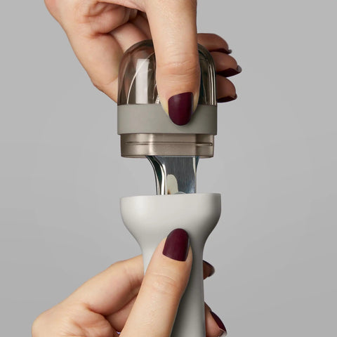 Hands opening Pocket Utensil Set in grey with 18/8 stainless steel fork, knife, and spoon nestled in a compact case for travel.