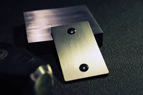 Close-up of titanium seed plate for beefed up security in crypto seed phrase storage for Bitcoin and Ethereum, includes 2 plates and seals.