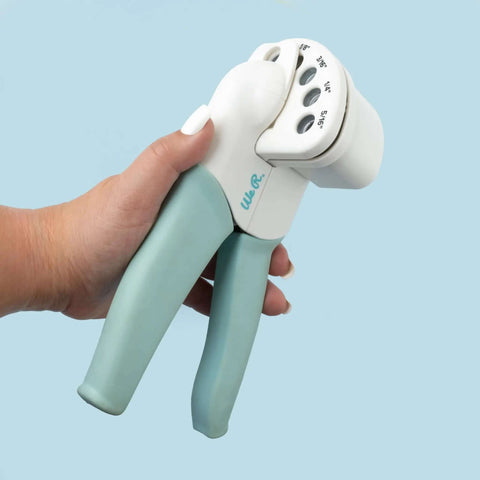 Hand holding Multi Size Hole Punch For Leather, Paper, Fabric And More Rotates Through Five Hole Sizes 1/16, 1/8, 3/16, 1/4, 5/16 Inch Holes