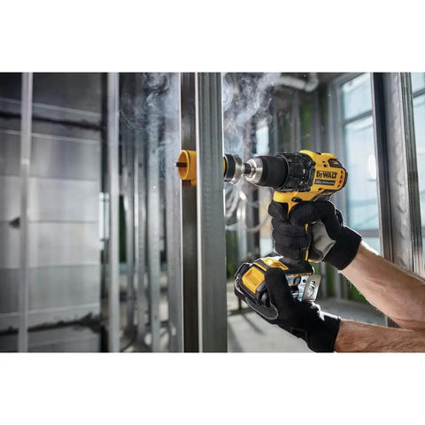 Person using Atomic 20V Max Cordless Drill Half Inch Chuck Tool Only Brushless Motor Variable Speed Trigger for drilling metal
