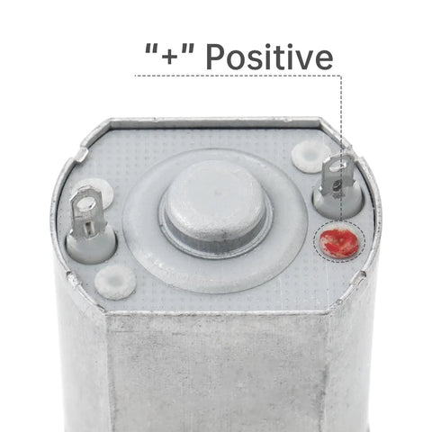 Close-up of 5V DC Gear Motor with Flat Shaft High Torque 11 RPM Output For Smart Door Lock showing positive terminal.