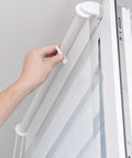 Hand using Shutter Repair Kit with Replacement Pins and Staples for Easy Louver Movement on white window blinds.