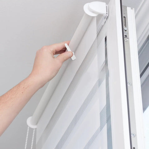 Hand using Shutter Repair Kit with Replacement Pins and Staples for Easy Louver Movement on white window blinds.